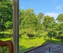 Blick aus dem Wintergarten - Gemeinde Berne: Außergewöhnliche Eigentumswohnung mit großen Nebengebäuden!